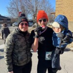 Un des coureurs savoure une médaille en biscuit à la ligne d’arrivée de la course de 5 km de Vanier.