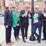 Raising the Franco-Ontarian flag. From left to right, Chris Greenshields, President of the Vanier Community Association, Mayor Mark Sutcliffe, Councillor Stéphanie Plante, MP Randy Boissonnault, Suzanne Lepine, Sergeant JP Perron, and MP Mona Fortier.
