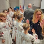 Stéphanie gives high fives to the Ukrainian Children's Choir before they sing the national anthem at council.
